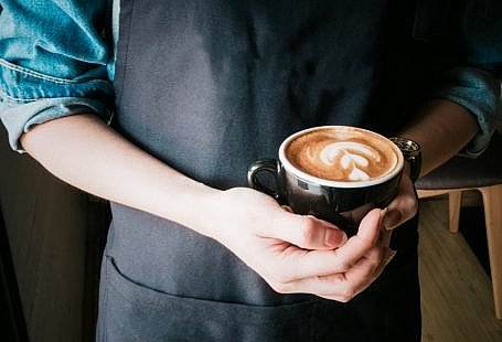 person serving free coffee